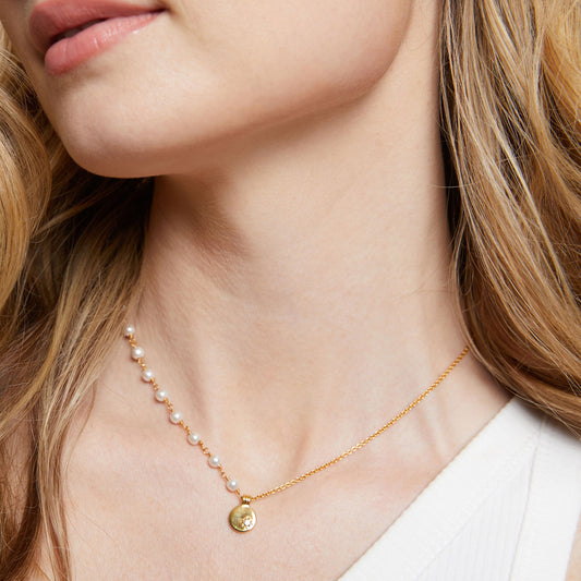 Delicate 18K gold PVD sterling silver necklace adorned with lustrous pearls and a round pendant, showcasing intricate detailing from Lanna Rose Jewelry 